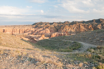 Sunset view of Charyn canyon in the Almaty region of Kazakhstan with a pathway in the foreground