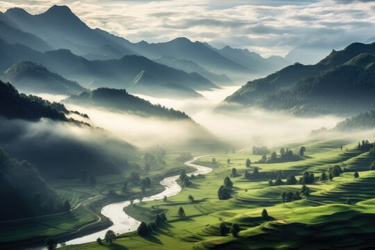 A stunning mountain landscape with a winding river amidst foggy valleys at sunrise.
