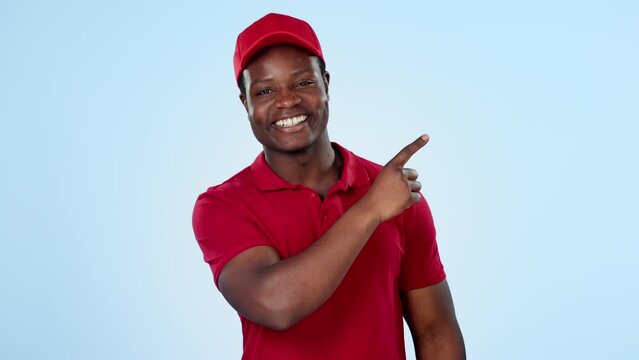 Delivery guy, space or pointing to offer, discount or distribution promotion on blue background. Face of happy black man, wrong choice or mockup for post service, sale or good review in studio