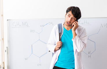 Young student chemist in the classroom