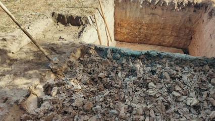 Pit in the ground. Digging a pit. The shovels in the pit. Earthworks, digging trench.