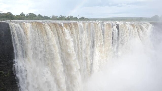 Slow motion footage of The great Victoria Falls waterfall in Zimbabwe at the border with Zambia. New 7 Natural Wonders of the World. Mosi-oa-Tunya on the river Zambezi.