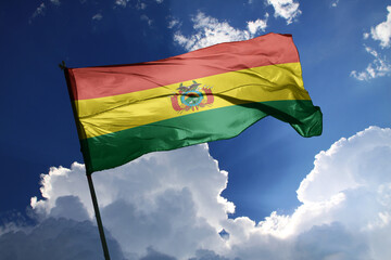 national flag of Bolivia waving in the wind on a clear day.