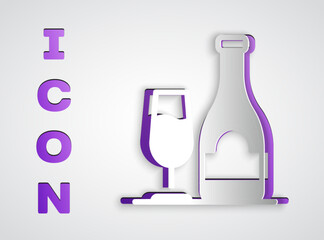 Paper cut Wine bottle with glass icon isolated on grey background. Paper art style. Vector