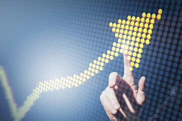 Close up of male hand pointing at creative yellow pixel upward arrow on blurry background. Growth,...