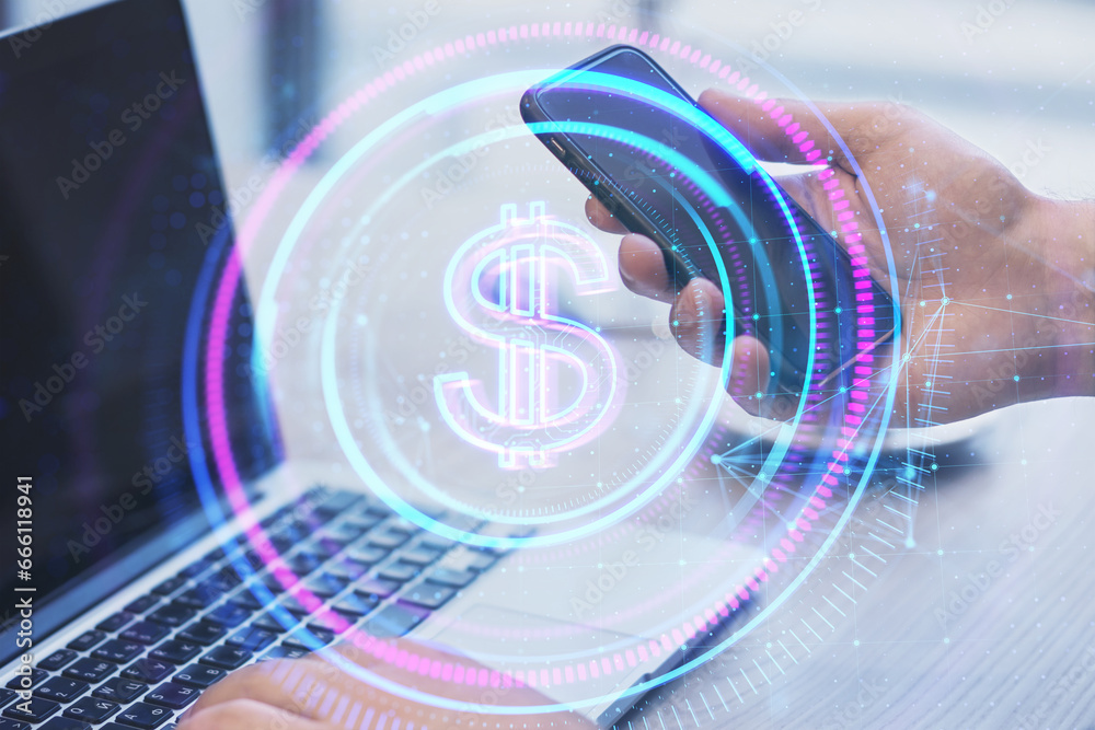 Poster Close up of businessman hands using laptop and cellphone at desk with glowing round polygonal button with dollar sign on blurry background. Online banking and money concept. Double exposure.