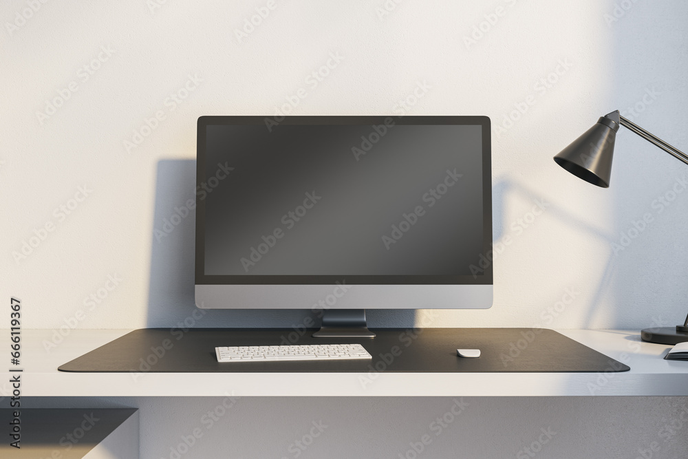 Fototapete Close up of modern workplace with empty mock up computer monitor and lamp. 3D Rendering.