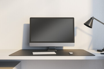 Close up of modern workplace with empty mock up computer monitor and lamp. 3D Rendering.