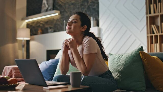Girl freelancer rejoicing notification payroll on smartphone sitting living room