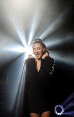 girl dancing at a party. on a background of bright confetti. Party in bright style. girl in the rays of light