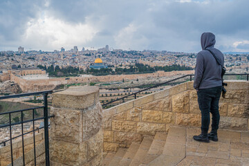 Young Israeli with machine gun overlooking Jerusalem Old City.