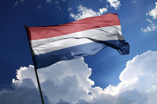 national flag of Netherlands waving in the wind on a clear day.