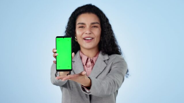 Businesswoman, phone and pointing at you with green screen in studio for opportunity on blue background. Entrepreneur, happy and excited for startup with presentation for recruitment on mobile app