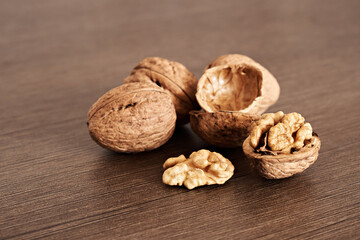 Kernels, shells and whole walnuts on a dark table. Healthy Eating.