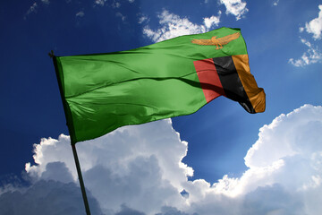 national flag of Zambia waving in the wind on a clear day.