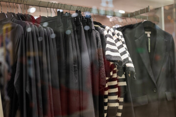 winter clothes  on hangers in a store on a showcase in a shopping center.