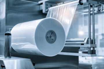 Automatic polyethylene plastic bag production machine with lighting effect. Close-up of the roller...