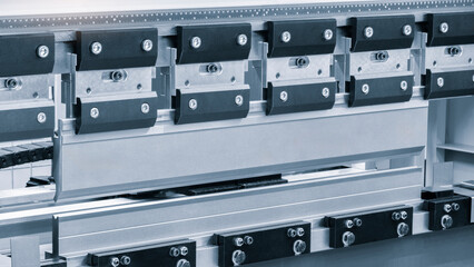 Bending sheet metal with a hydraulic machine at the factory. Closeup.