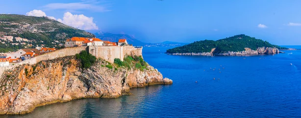 Poster Panoramic of old town Dubrovnik , view of fortified wall and castle from the sea side. Croatia travel and historic landmarks © Freesurf