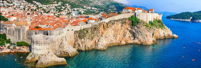 Poster Panoramic of old town Dubrovnik , view of fortified wall and castle from the sea. Croatia travel and historic landmarks © Freesurf