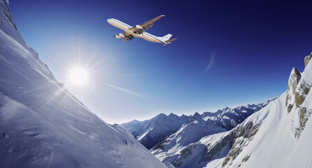 Passenger plane flying between snowy mountains. Fast travel, vacation and business concept.