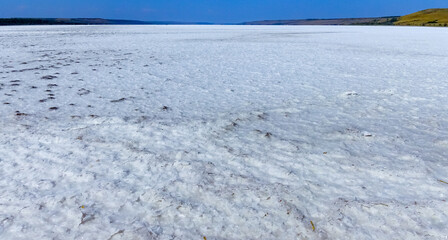 covered with a layer of white self-precipitating common salt