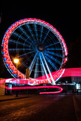 Ferris wheel with light trails. Kolobrzeg at night.  Kołobrzeg is city in Poland. 