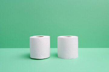 several rolls of toilet paper on a plain background. generative ai