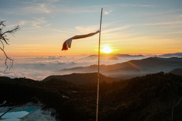 Indonesian Flag Fluttering Amidst Kawah Putih's Mystical Aura