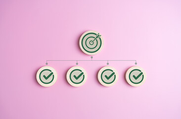Business target successful project plan. Dartboard and correct sign on wooden blocks in pink...