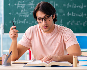 Young male student in the classroom