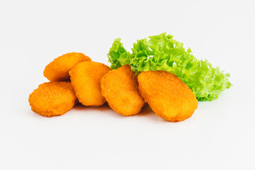 Breaded chicken nuggets.Breaded Chicken Inner Fillet with green lettuce leaves on a White Background.Chicken Breaded Raw Meat,Fillet.Fast homemade food at home. Chicken breaded schnitzels.Fast cooking