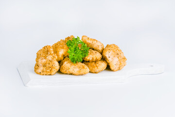 Chicken Breaded Fillet.Fast food. Breaded Chicken Inner Fillet on a White Background,Chicken Breaded Raw Meat. Fast cooking. Breaded chicken nuggets. Homemade food at home.
