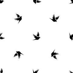 Seamless pattern of repeated black bird symbols. Elements are evenly spaced and some are rotated. Illustration on transparent background