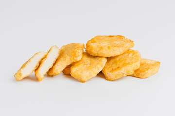 Breaded Chicken Inner Fillet on a White Background,Chicken Breaded Raw Meat.Chicken Breaded Fillet.Fast food. Fast cooking. Breaded chicken nuggets. Homemade food at home.