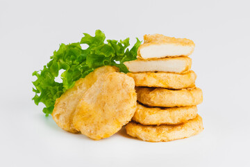 Breaded Chicken Inner Fillet on a White Background,Chicken Breaded Raw Meat.Chicken Breaded Fillet.Fast food. Fast cooking. Breaded chicken nuggets. Homemade food at home.