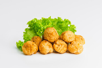 Breaded chicken nuggets.Breaded Chicken Inner Fillet with green lettuce leaves on a White Background.Chicken Breaded Raw Meat,Fillet.Fast homemade food at home. Chicken breaded schnitzels.Fast cooking
