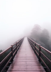 wooden bridge leading up to a foggy hill, generative ai