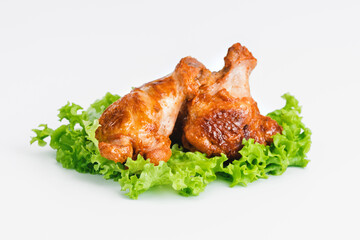 Chicken wings fried until half cooked, semi-finished product with fresh herbs on a white background. Fast food. Fast cooking.Quick cooking at home. Copy space.Fast homemade food.Raw chicken meat.
