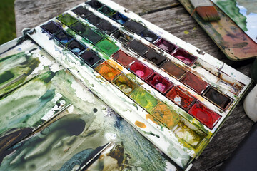 Art palette with colorful paints, close-up