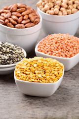 Raw chana dal with red lentils in bowl at table