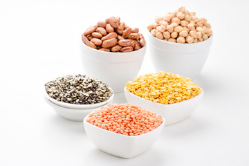 Uncooked red lentils with kidney beans and chana dal isolated on white background
