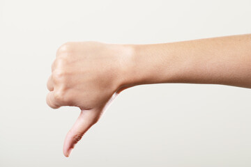 Thumbs down hand isolated on white background, disagree hand gesture - obrazy, fototapety, plakaty