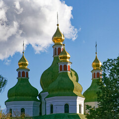 Fototapeta na wymiar Domes of an Orthodox church against the sky. Orthodox baroque architecture. Clear sky. An old religious building.