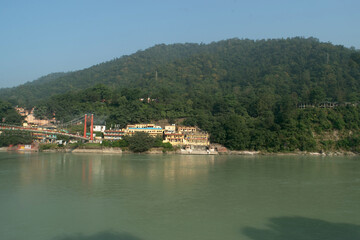 Fototapeta na wymiar Ganga river with green mountains at rishikesh, uttarakhand