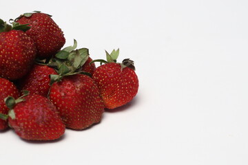 
Some fresh ripe red strawberries have green leaf petals.