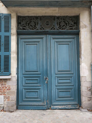 blue painted frontdoor in Lille, France wit a decorated house number 99