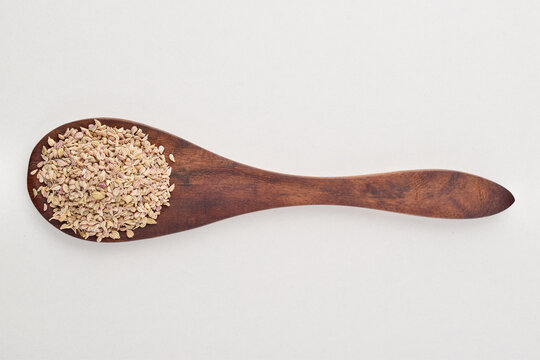 Top view of carom seeds in spoon on white background