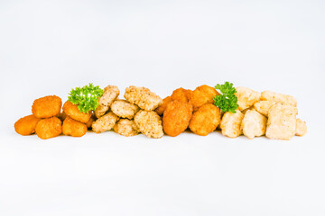 Assorted Breaded Chicken Inner Fillet,Chicken Breaded Raw Meat.Fast cooking.Breaded Chicken nuggets Fillet with salad on a White Background,food at home.Fast homemade food.Chicken breaded schnitzels.