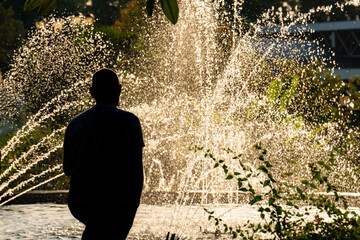 Silhouette of a man at the fountain